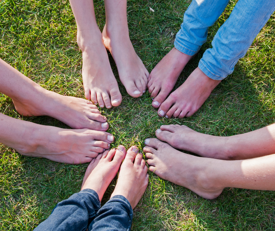 a group of feet on grass